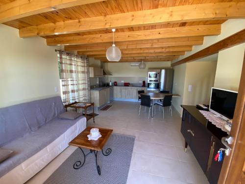 a living room with a couch and a table at Les Lavandes in Tréjouls