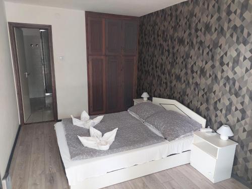 Un dormitorio con una cama con flores blancas. en Villa Malazzo, en Balatongyörök