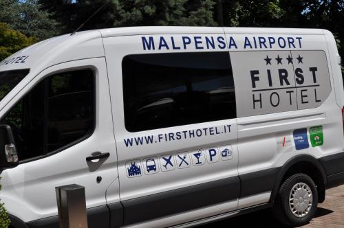 a white van with a first hotel on the side at First Hotel Malpensa in Case Nuove