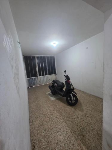a motor scooter parked in a room at Apt con Aire y Tina in Yopal