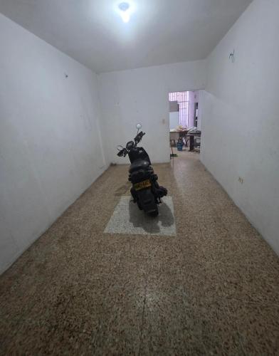 a motorcycle parked in a room with a hallway at Apt con Aire y Tina in Yopal