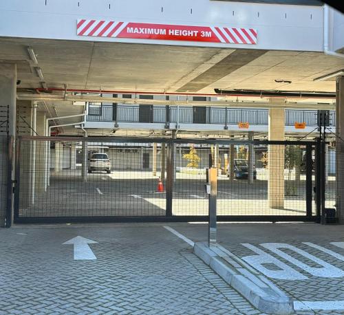 an empty parking lot with a gate in a parking garage at Paarl Winelands Retreat in Paarl