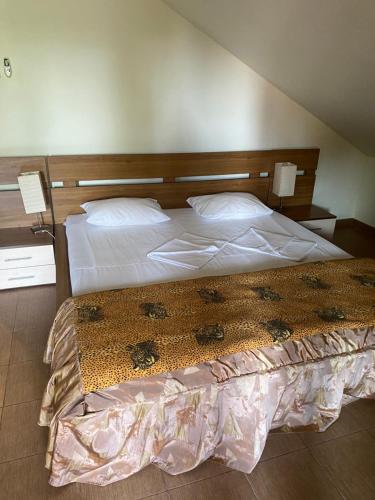 une chambre avec un grand lit avec deux oreillers dans l'établissement Vila Doda, à Eforie Nord