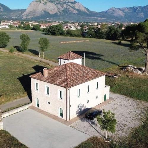 an aerial view of a white house in a field at Tenuta Mea in Teggiano