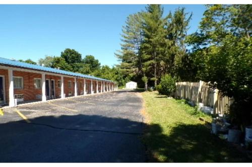 an empty street in front of a brick building at Hotel O Relax Inn Lewisburg near I-64 in Lewisburg