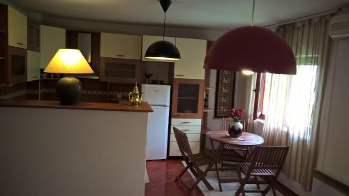 a kitchen and dining room with a table and chairs at Guest House Goa Mostar in Mostar