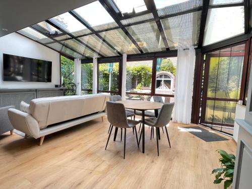 a living room with a couch and a table and chairs at Spreewaldapartments-Kossatz in Lübben