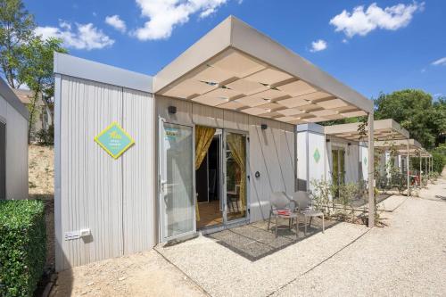 a small white building with a pitched roof at hu Firenze Certosa camping in town in Impruneta