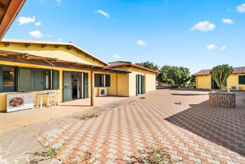 a house with a brick driveway in front of it at Residence Sulcis 2 in Masainas