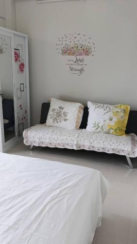 a bedroom with a bed with pillows and a mirror at Royal Oceancrest Panglao Seaview in Dauis