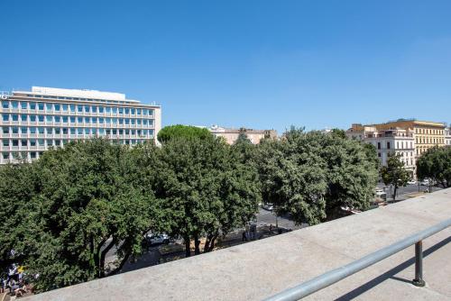 a row of trees in a city with buildings at Fortyfive Squared Hotel in Rome