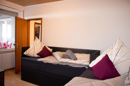 a bedroom with a bed with pillows on it at Gästewohnung Mönchengladbach in Mönchengladbach