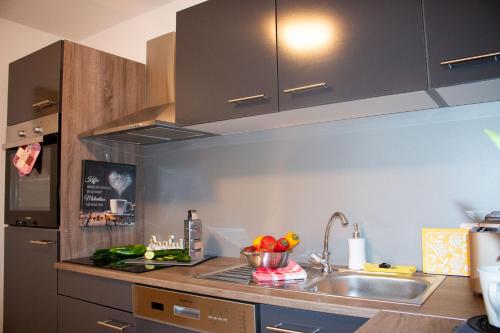 a kitchen with a sink and a refrigerator at Gästewohnung Mönchengladbach in Mönchengladbach