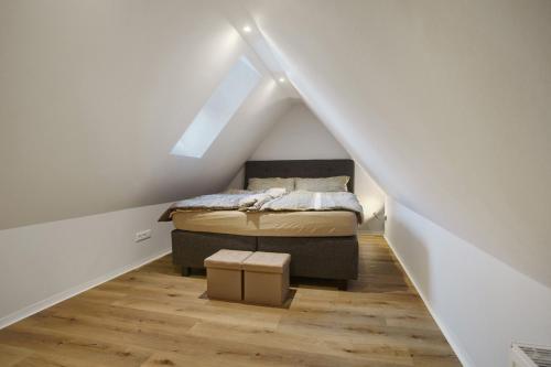 a small bedroom with a bed in a attic at Ostseeperle in Boltenhagen