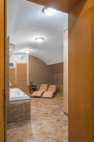 a room with a bed and a bath tub at Hotel U Zlatého kohouta in Kroměříž
