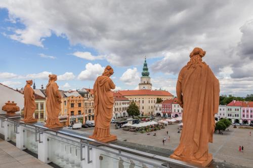 a group of statues on top of a building at Hotel U Zlatého kohouta in Kroměříž