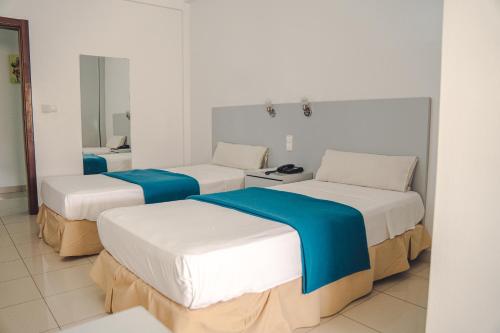 Postel nebo postele na pokoji v ubytování Hotel LIVVO Don Paco