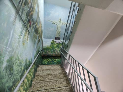 a stairway with a painting of a statue in a building at Cassino All Inclusive Resort Poços de Caldas By Nacional Inn in Poços de Caldas