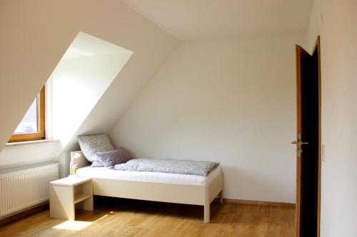 a small bedroom with a bed in a attic at Fränkische Seenliebe in Gunzenhausen