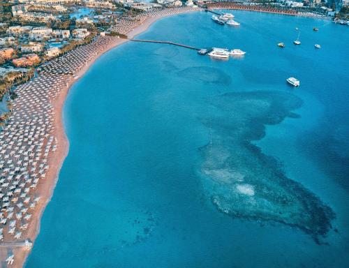 an aerial view of a beach with boats in the water at JAZ Makadi Saraya Resort in Hurghada