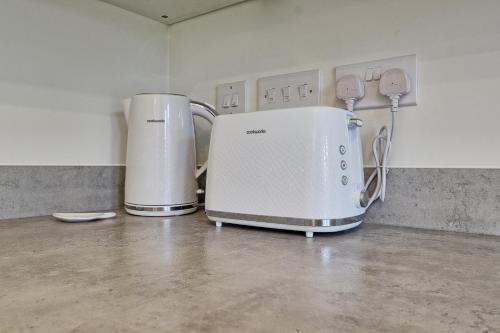 two coffeemakers sitting on a counter in a room at Luxury and cosy 2 bed entire house in Essex 20 mins from beach in Colchester