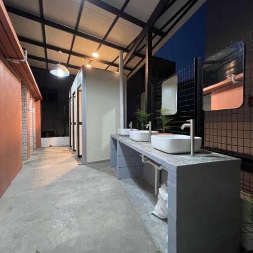 a bathroom with three sinks on a counter at Miner's House Ipoh in Ipoh