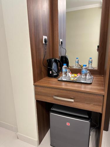 a vanity in a hotel room with a mirror at HAVEN TOWER in Juffair