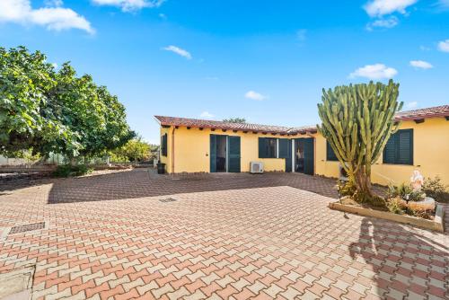 a house with a brick driveway in front of it at Residence Sulcis 3 in Masainas