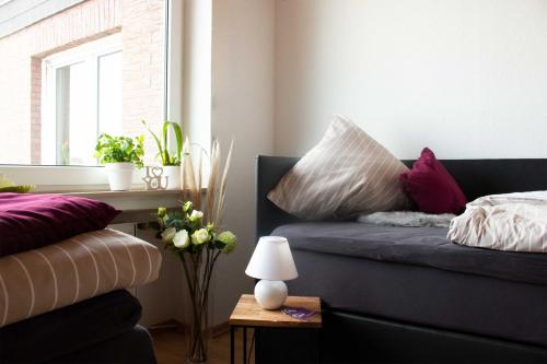 a bedroom with a bed with purple and white pillows at Gästewohnung Mönchengladbach in Mönchengladbach