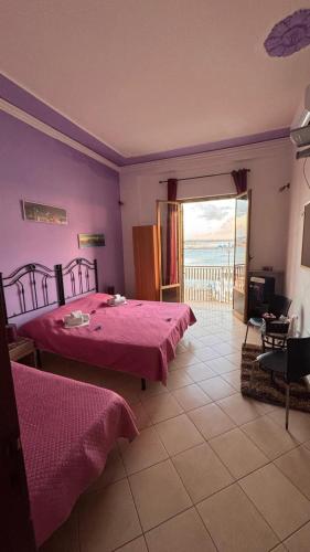 a bedroom with two beds and a view of the ocean at Beb al porto da joseph in Trapani