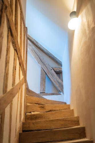 a set of stairs in a building with a light bulb at Le Domaine de Richebourg - Pierres d'Histoire in Richebourg