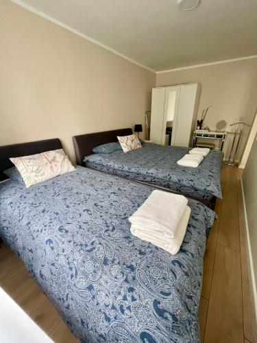 two beds sitting next to each other in a bedroom at V5 central in Valmiera