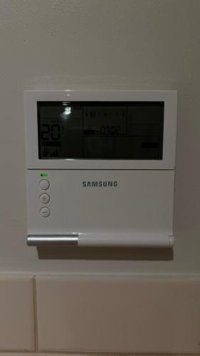 a microwave oven sitting on top of a wall at 2 Bdrm Walkerville Apartment - Spacious, ducted heating & cooling, centerally located! in North Adelaide