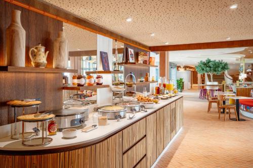 a kitchen with a counter with food on it at La Résidence - Thalazur Arcachon in Arcachon