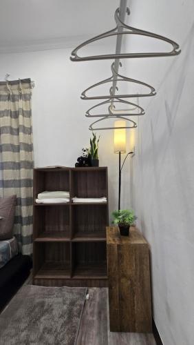a chandelier in a living room with a wooden table at Tuaran Village Guesthouse in Tuaran