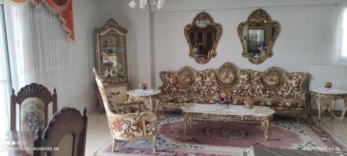 a living room with a couch and a table and mirrors at Delux 3 Bedroom Apartment Exceptional Location in Sparti