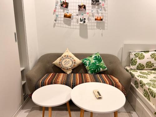 a living room with a couch and two tables at Vinhomes Grand Park Homestay-The Beverly Hills in Long Bình