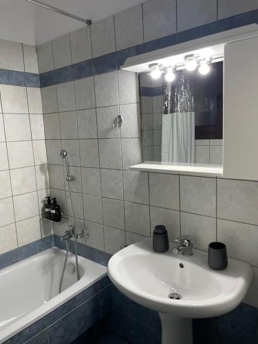 a bathroom with a sink and a bath tub at The Hidden Lodge in Karpenision