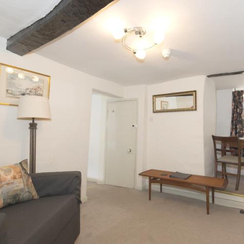 a living room with a couch and a table at Rydal Lodge in Rydal