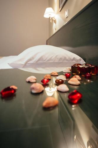 a glass table with cookies on top of a bed at Ignatia Hotel in Nafplio