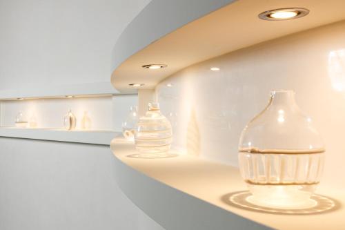 two glass bottles sitting on a shelf in a room at Hotel Mariver in Lido di Jesolo