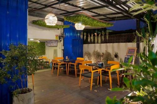 a restaurant with tables and chairs in a room at BW Studios thai art style in Chiang Mai