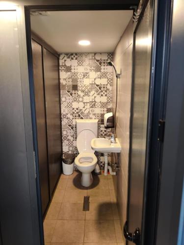 a small bathroom with a toilet and a sink at Arest Vama Veche in Vama Veche