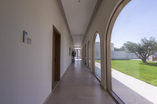 an empty hallway of a building with an archway at Ivory House Resort - Ophiolite in Hatta