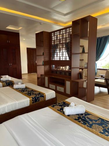 a hotel room with two beds and a desk at Thanh Dat Resort in Can Tho