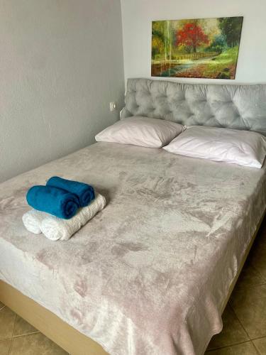 a bed with two towels on top of it at Blue Panorama Diamond in Mákri