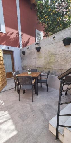a wooden table and chairs on a patio at Apartamentos Les Texuques in Nueva de Llanes