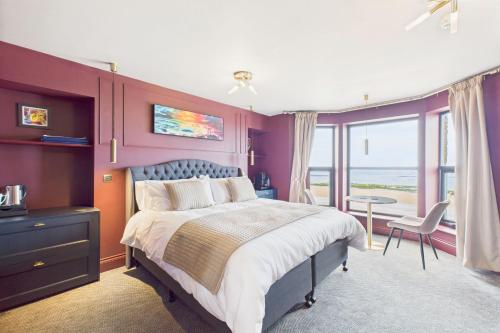 a bedroom with a large bed with purple walls at Host & Stay - Bellevue Luxe Rooms in Redcar