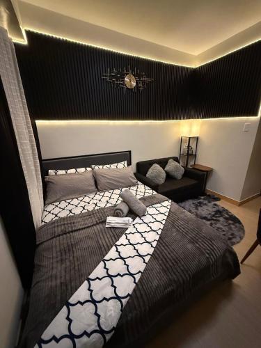 a bedroom with a large bed in a room at Condo in Fairview SM Terraces Cozy Netflix in Manila