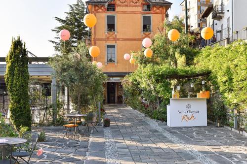 a courtyard with tables and chairs and balloons at Casa Vacanze Panorama in Brunate
